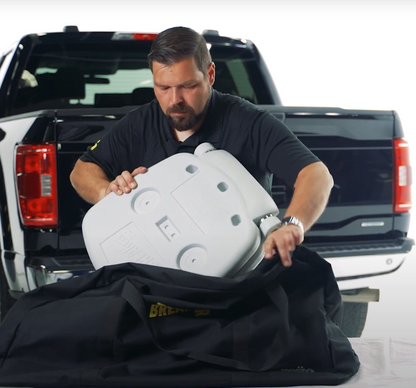 George packing Tailbreaker hitch mounted seating system seats into branded carrying bag for easy storage and travel