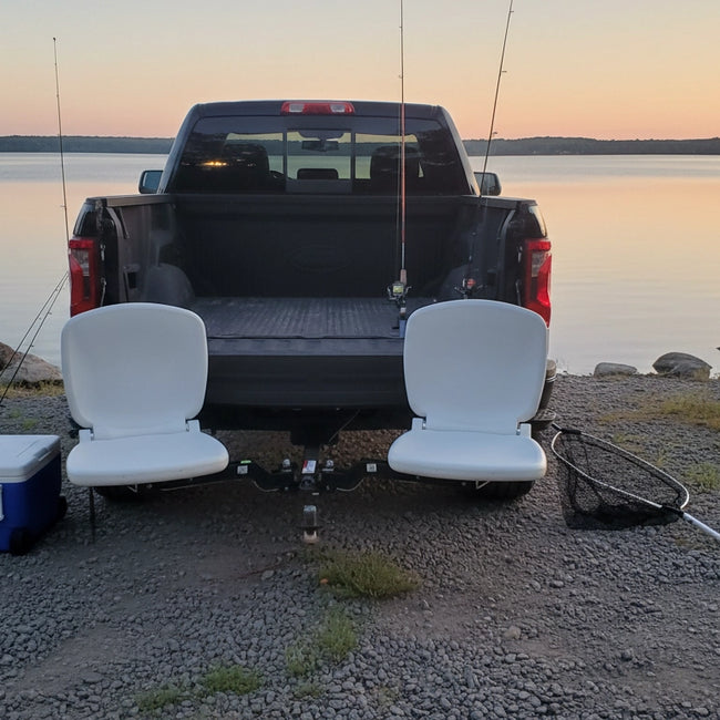 Fishing gear set up on Tailbreaker hitch mounted truck accessory seating system next to lake – stable seating for outdoor anglers.