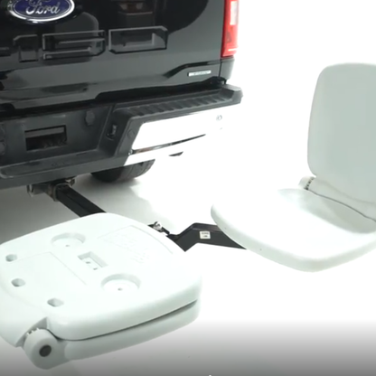 Ultimate hitch mounted seat tailbreaker on white background.one seat is open the other is folded closed. On black ford pick up truck