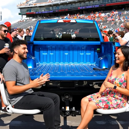 Two people enjoying a tailgating event using the Tailbreaker truck accessory attached to a blue Chevy  pick up truck.